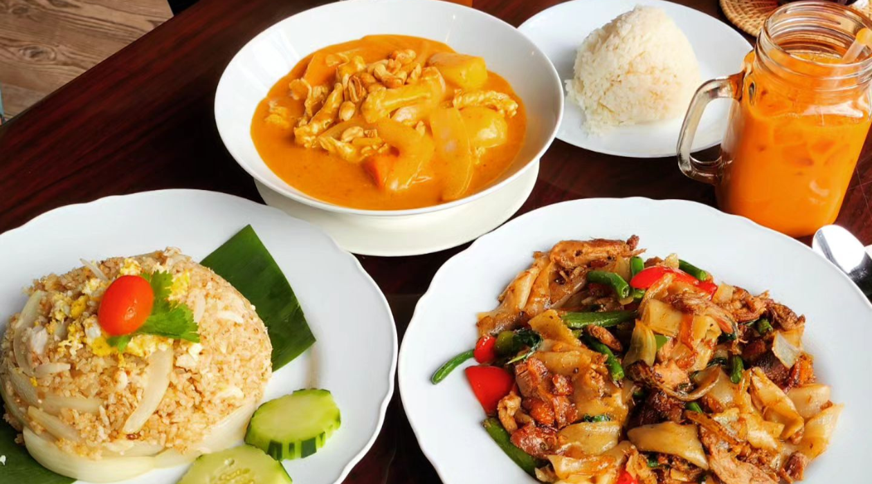 Assortment of Thai tea, Thai curry, rice, vegetables and other dishes at Lopburi Thai in Wappingers Falls